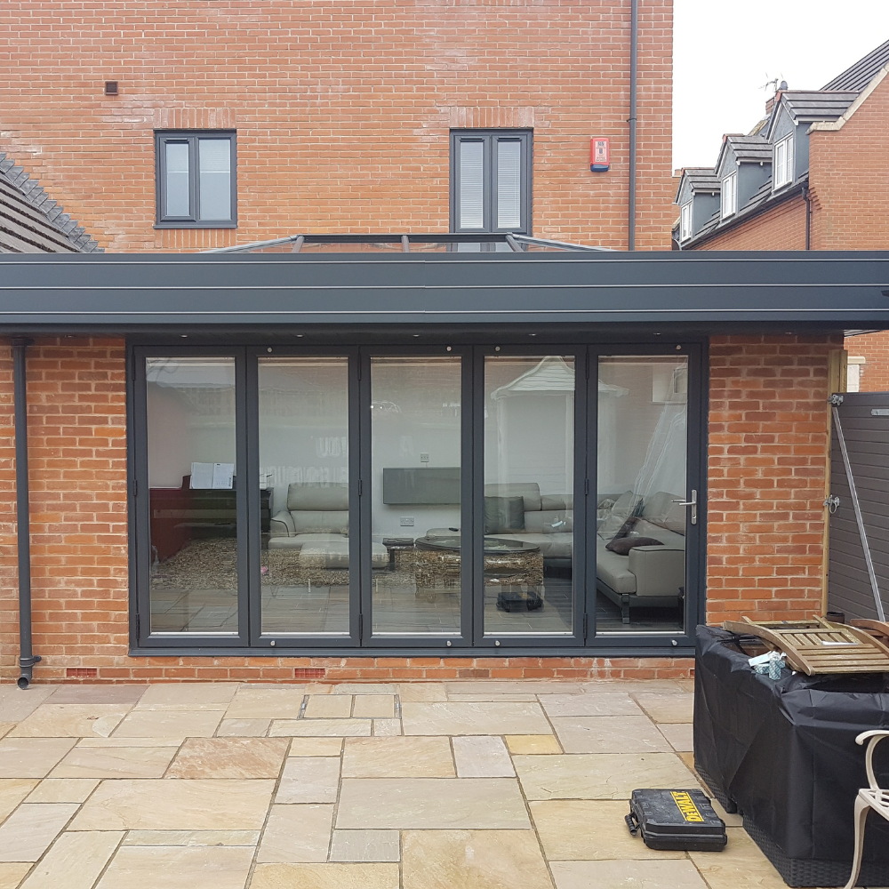 Closed bifold doors on brick extension